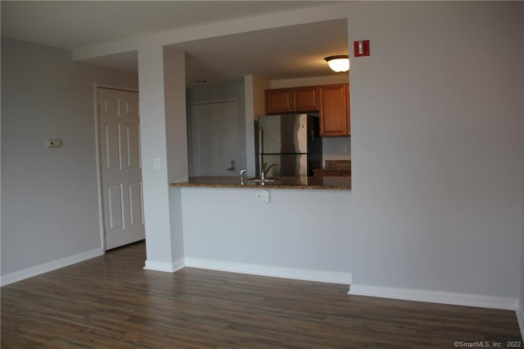 300 Broad Street, Unit 607 Stamford, CT 06901 - Photo 12 of 25 a view of an empty room with wooden floor and a cabinet