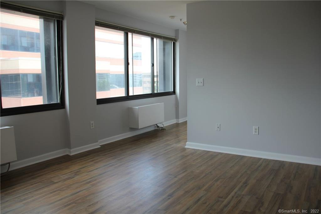 300 Broad Street, Unit 607 Stamford, CT 06901 - Photo 15 of 25 an empty room with wooden floor and windows