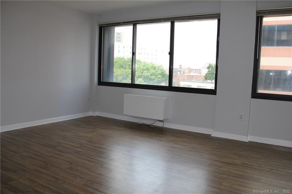 300 Broad Street, Unit 607 Stamford, CT 06901 - Photo 16 of 25 an empty room with wooden floor and windows