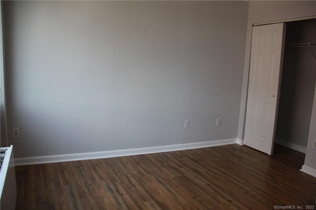 300 Broad Street, Unit 607 Stamford, CT 06901 - Photo 18 of 25 a view of an empty room with wooden floor