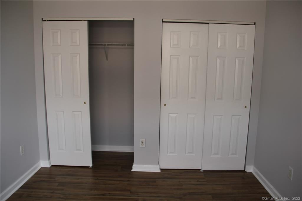 300 Broad Street, Unit 607 Stamford, CT 06901 - Photo 19 of 25 a view of an empty room with wooden floor