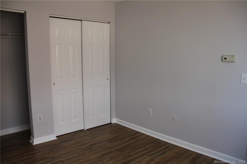 300 Broad Street, Unit 607 Stamford, CT 06901 - Photo 20 of 25 a view of an empty room with wooden floor