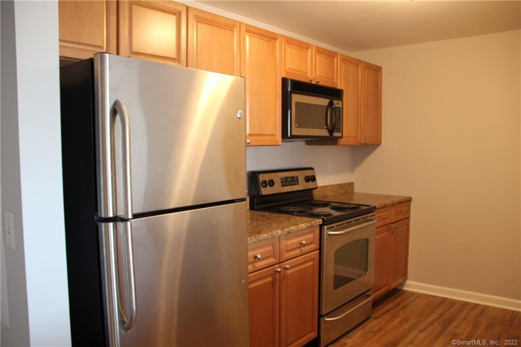 300 Broad Street, Unit 607 Stamford, CT 06901 - Photo 2 of 25 a white refrigerator freezer and a stove sitting inside of a kitchen
