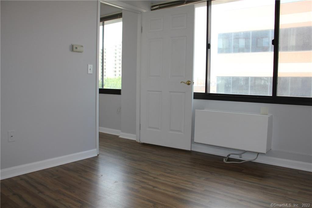 300 Broad Street, Unit 607 Stamford, CT 06901 - Photo 21 of 25 an empty room with wooden floor and windows