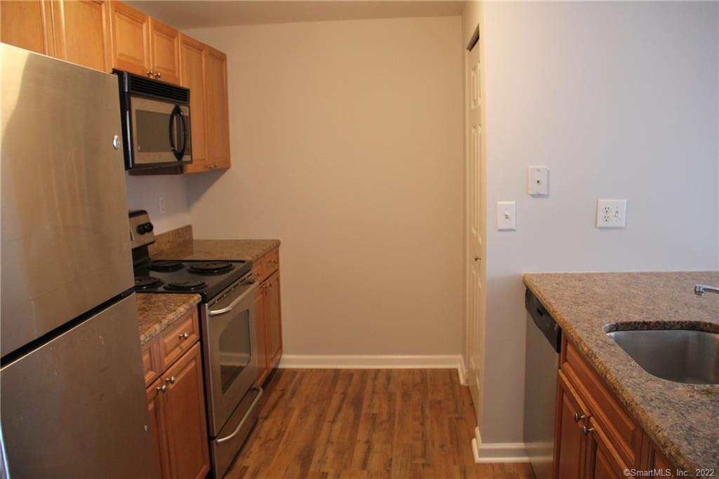 300 Broad Street, Unit 607 Stamford, CT 06901 - Photo 4 of 25 a kitchen with a sink a stove and cabinets