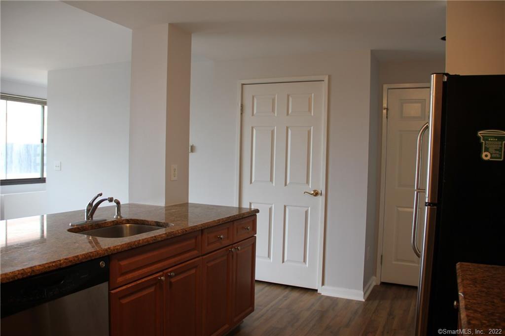 300 Broad Street, Unit 607 Stamford, CT 06901 - Photo 5 of 25 a kitchen with a sink and a refrigerator