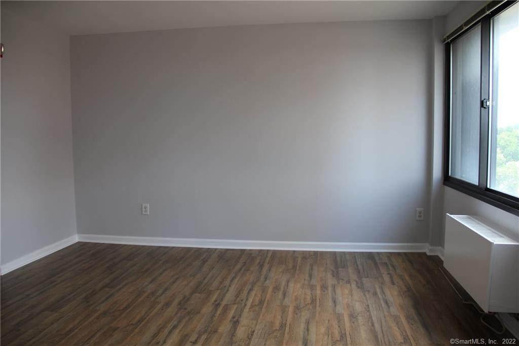 300 Broad Street, Unit 607 Stamford, CT 06901 - Photo 8 of 25 a view of a room with wooden floor and a window