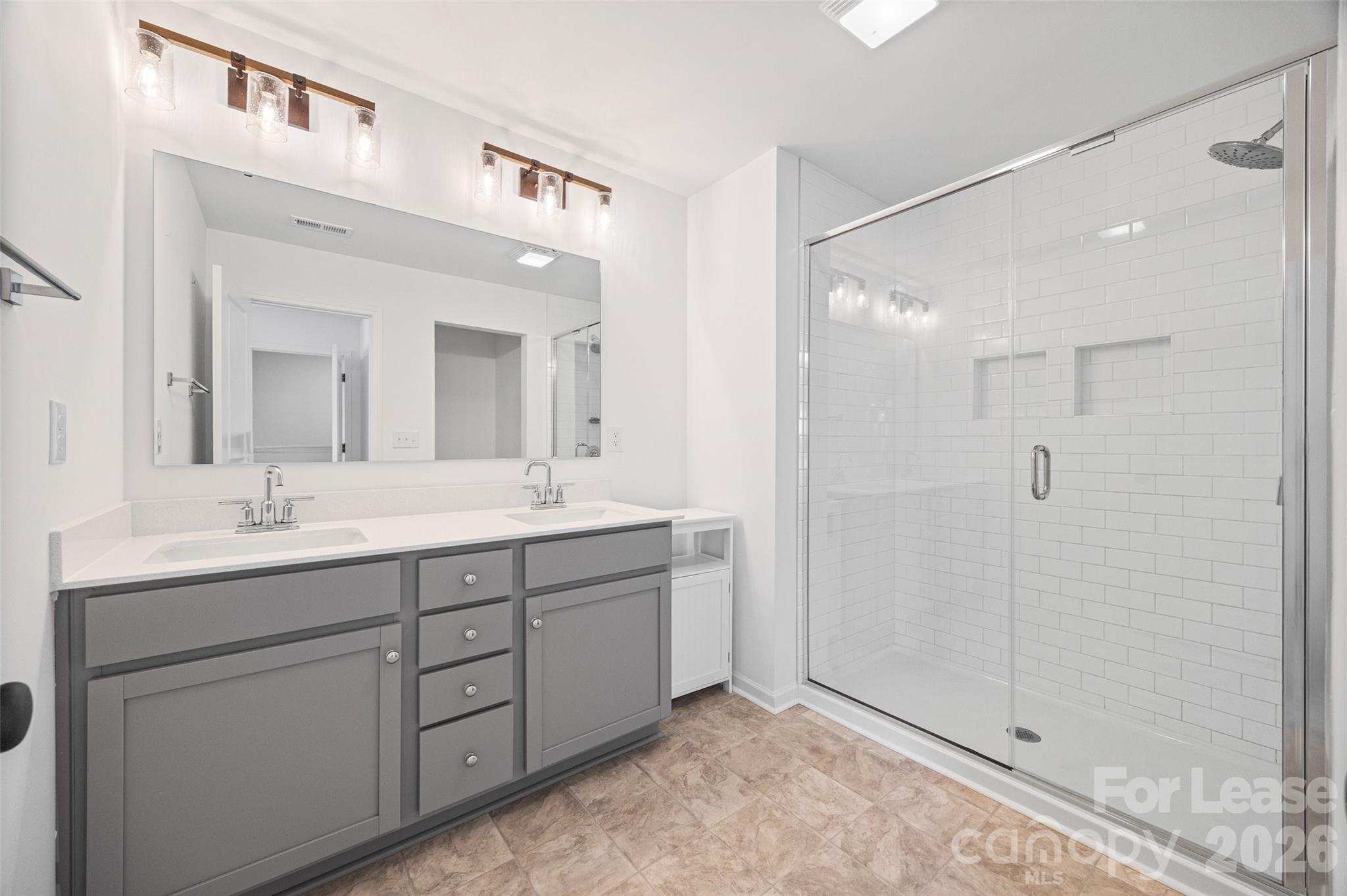 512 Station Street Clover, SC 29710 - Photo 21 of 34 a bathroom with a double vanity sink mirror and shower