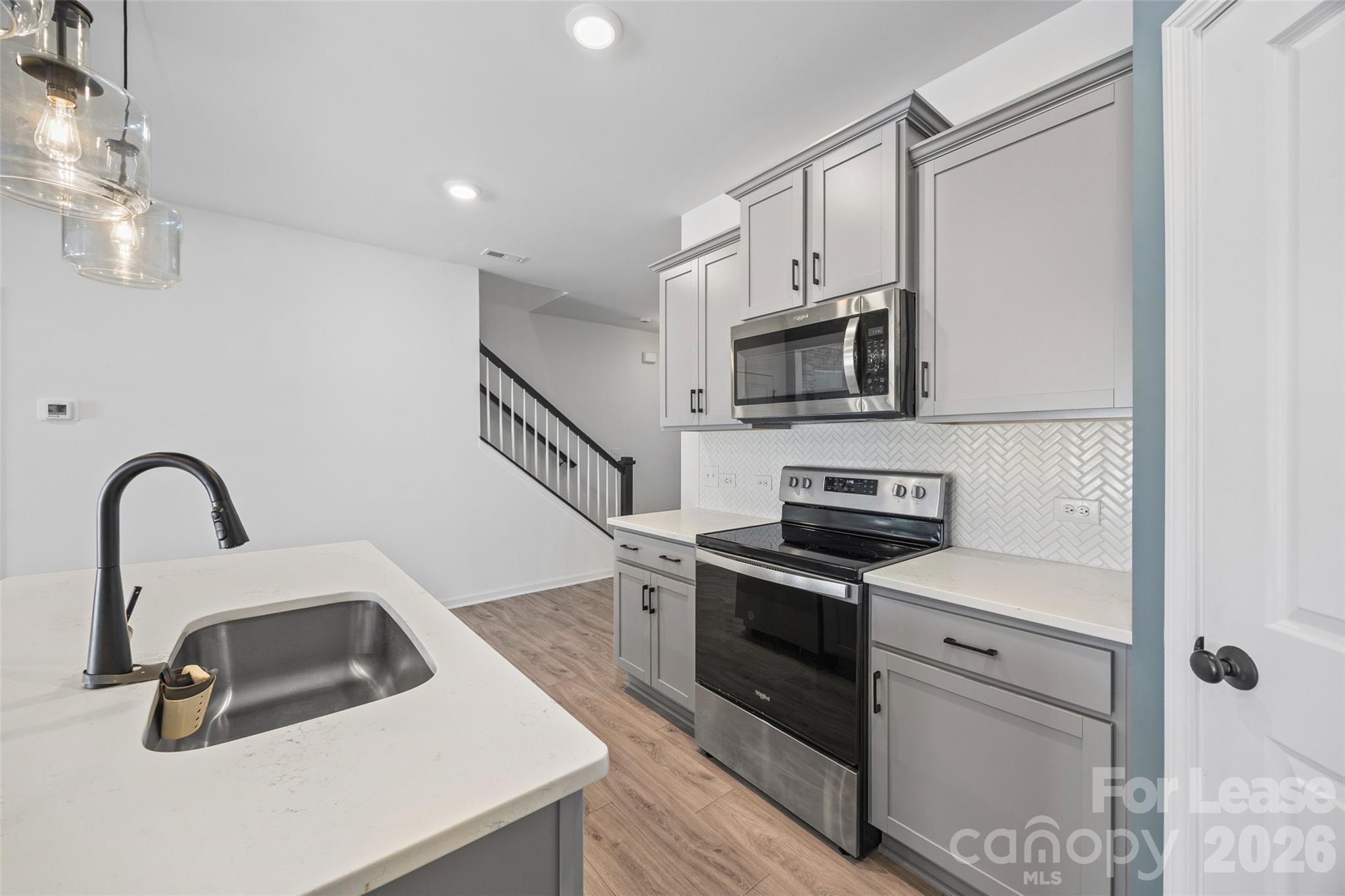 512 Station Street Clover, SC 29710 - Photo 6 of 34 a kitchen with a sink a stove and microwave