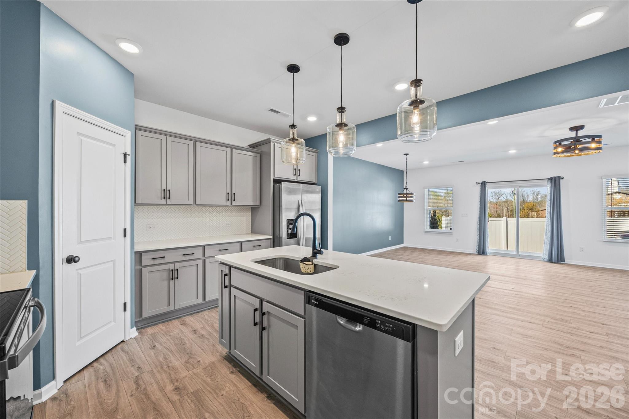 512 Station Street Clover, SC 29710 - Photo 7 of 34 a kitchen with a sink a center island a stove a refrigerator cabinets and living room view