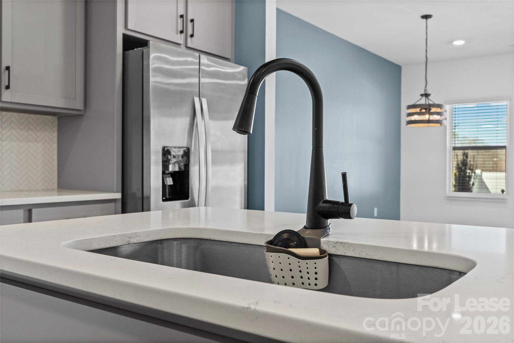 512 Station Street Clover, SC 29710 - Photo 8 of 34 a kitchen with a faucet a sink and a refrigerator with wooden floor