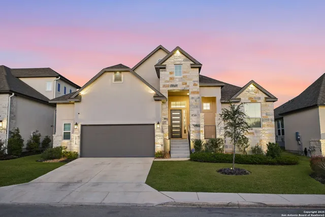a front view of a house with a yard and garage