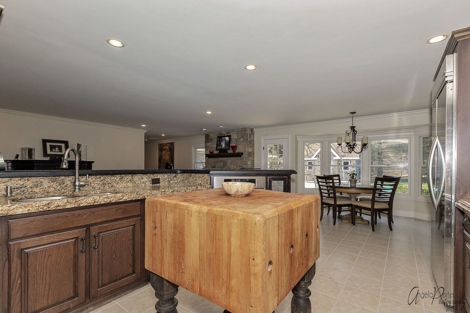 1018 Sunset Road Spring Grove, IL 60081 - Photo 13 of 54 a dining hall with stainless steel appliances granite countertop a dining table chairs and white cabinets