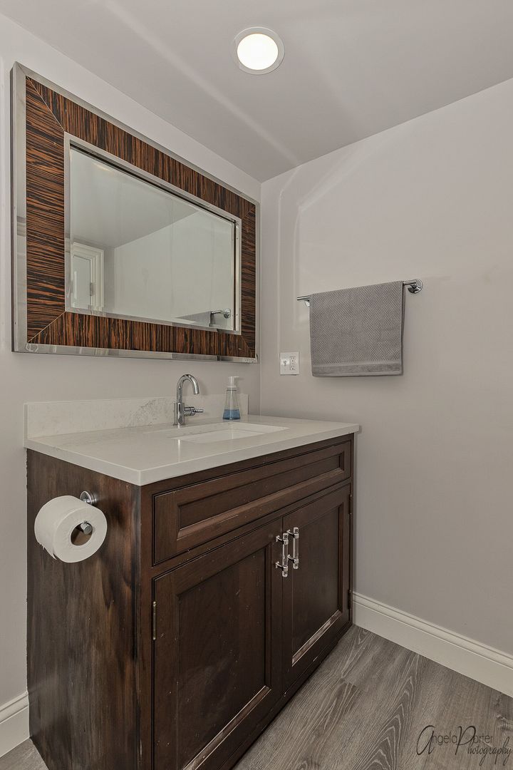 1018 Sunset Road Spring Grove, IL 60081 - Photo 38 of 54 a bathroom with a sink vanity and a mirror