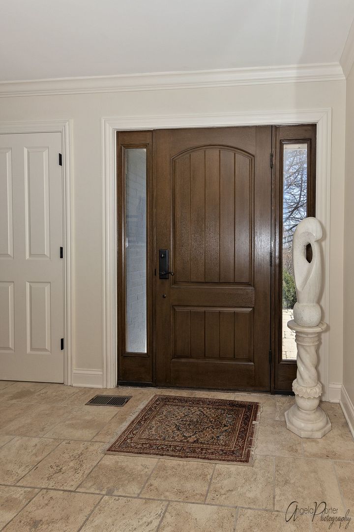 1018 Sunset Road Spring Grove, IL 60081 - Photo 5 of 54 a view of a hallway with toilet and a front door