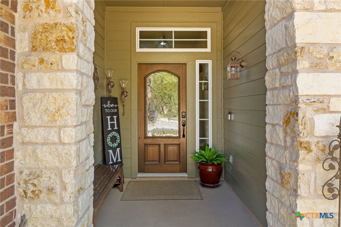 20525 Jackies Ranch Boulevard Pflugerville, TX 78660 - Photo 29 of 30 View of exterior entry featuring stone siding and a porch