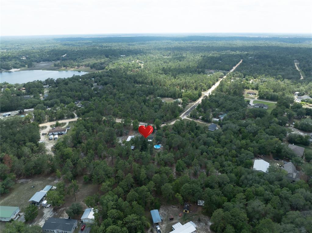 5670 Acadia Street Keystone Heights, FL 32656 - Photo 64 of 65 an aerial view of residential houses with outdoor space and trees