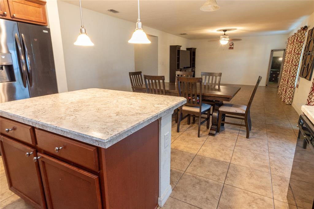 4563 Orchard Grove Road St. Cloud, FL 34772 - Photo 40 of 51 a large kitchen with a table and chairs
