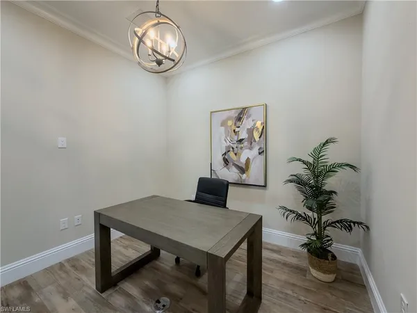 a view of a room with a table and chairs