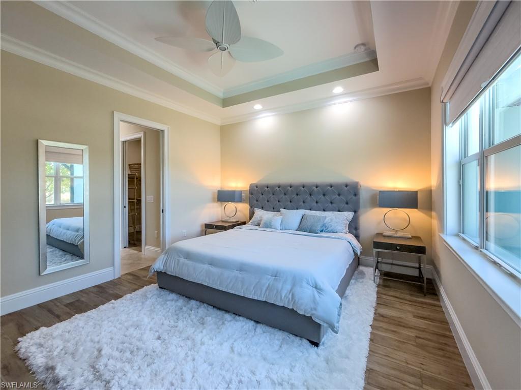 6399 Negril Isle Drive Naples, FL 34113 - Photo 12 of 33 a bedroom with a large bed and a window