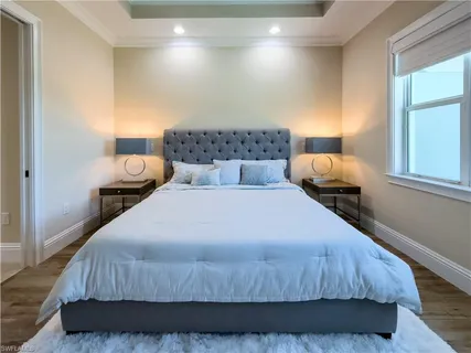 a bedroom with a bed and window