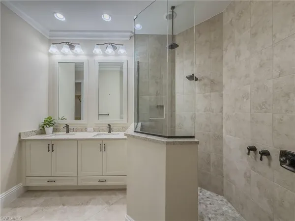 a bathroom with a double vanity sink and mirror