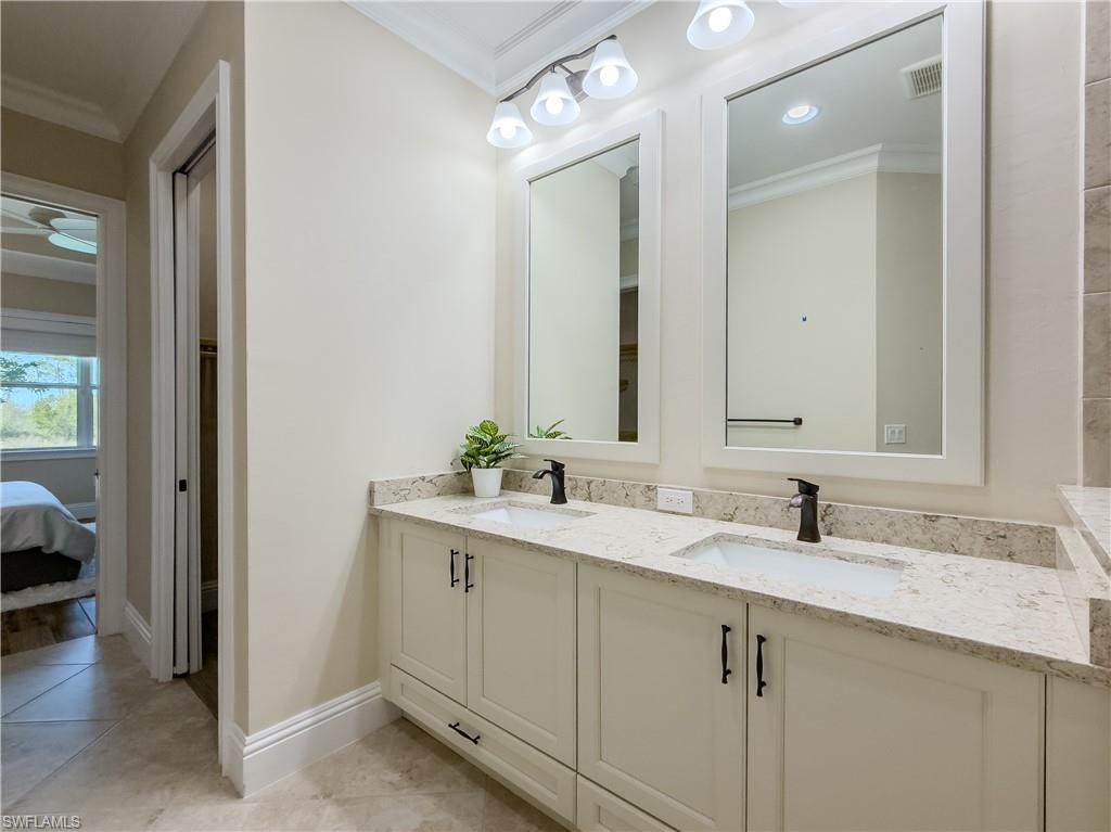 6399 Negril Isle Drive Naples, FL 34113 - Photo 16 of 33 a bathroom with a sink and a mirror