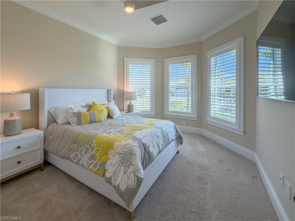 6399 Negril Isle Drive Naples, FL 34113 - Photo 17 of 33 a spacious bedroom with a bed and a window