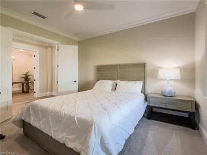 a bedroom with a bed and lamp