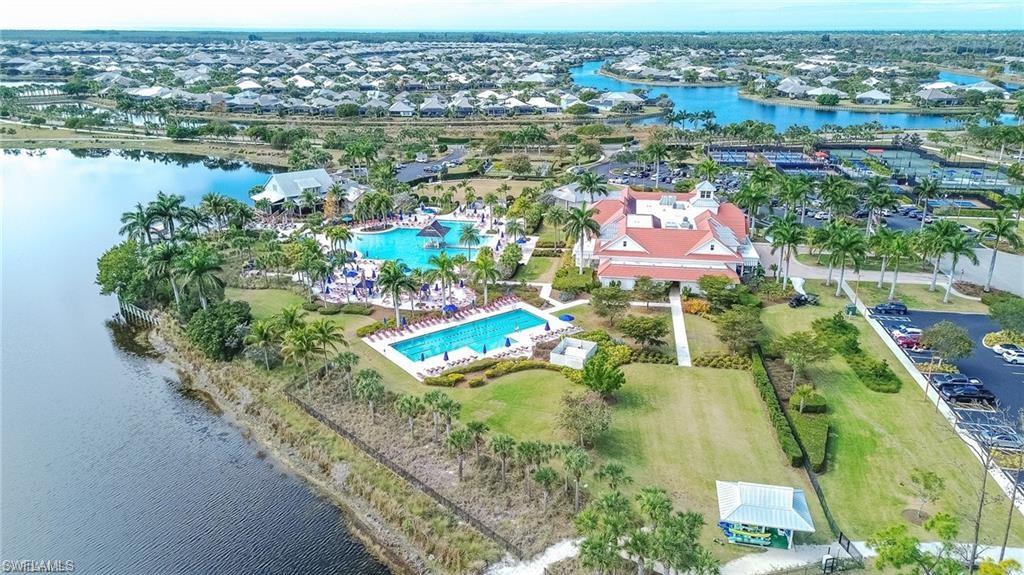 6399 Negril Isle Drive Naples, FL 34113 - Photo 28 of 33 an aerial view of residential houses with outdoor space and lake view