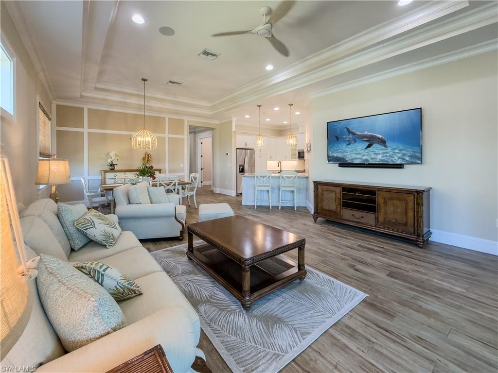 6399 Negril Isle Drive Naples, FL 34113 - Photo 3 of 33 a living room with furniture and a fireplace