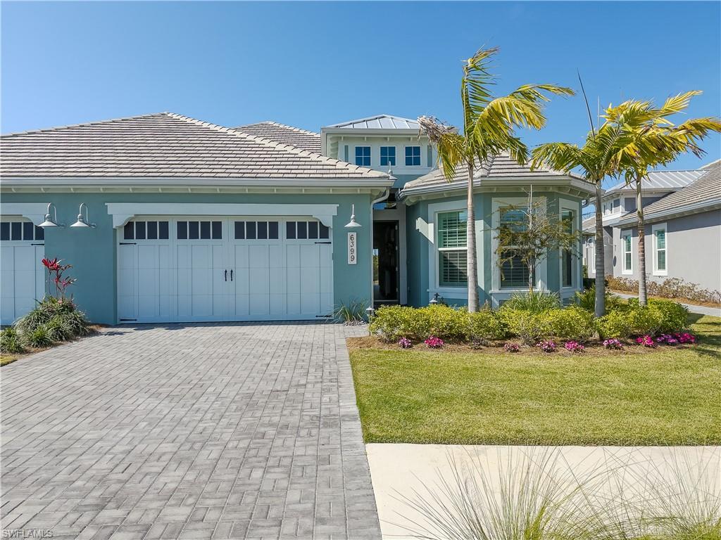 6399 Negril Isle Drive Naples, FL 34113 - Photo 32 of 33 a front view of a house with a garden and plants