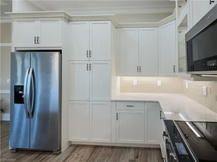 a kitchen with a refrigerator and cabinets