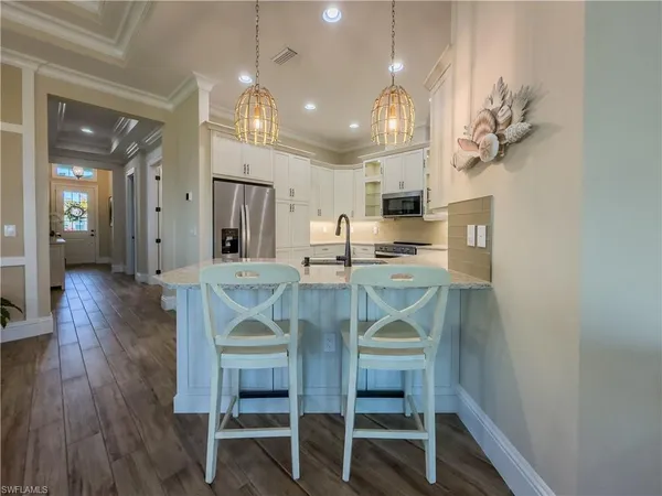 a view of a dining room with furniture and wooden floor