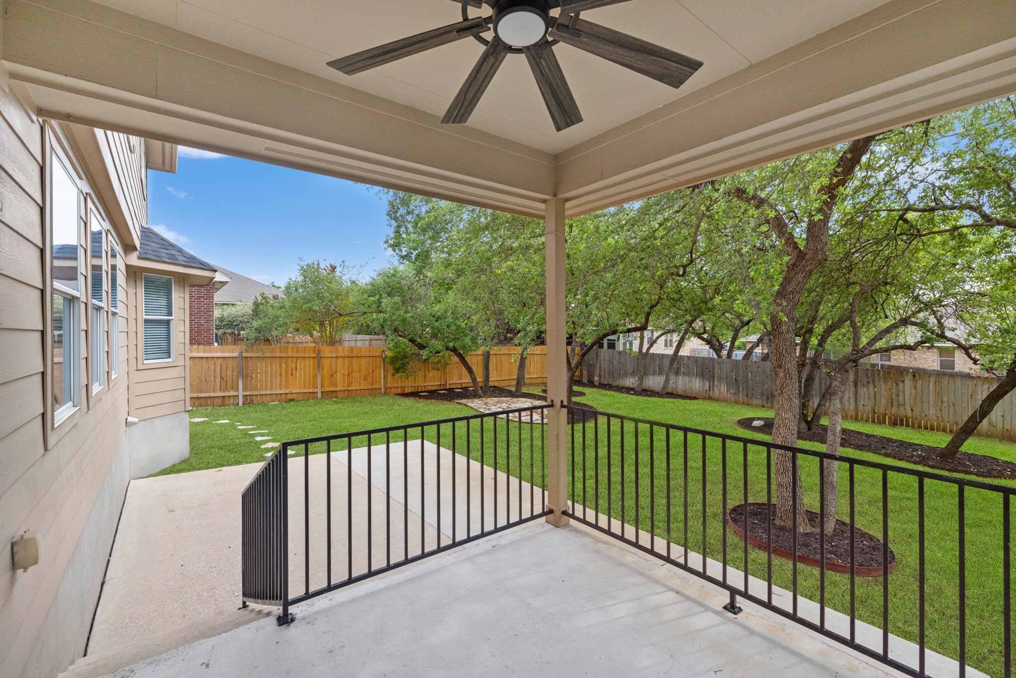 403 Red Hawk Drive Leander, TX 78641 - Photo 28 of 37 Covered patio featuring a ceiling fan, concrete flooring, and black metal railing