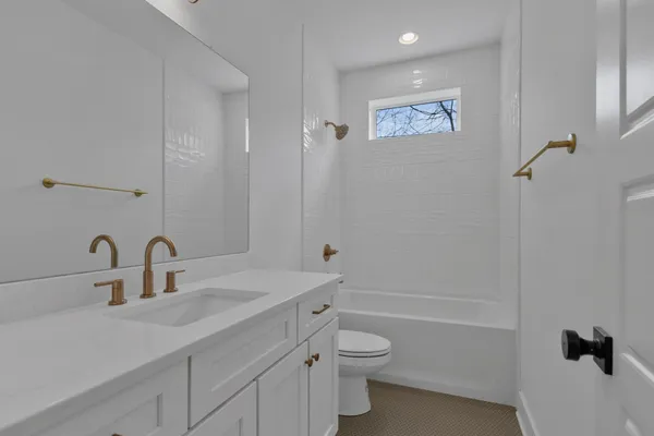 a bathroom with a double vanity sink and mirror