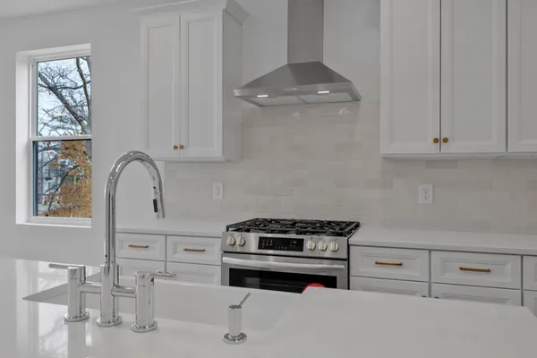 a kitchen with granite countertop white cabinets and white appliances