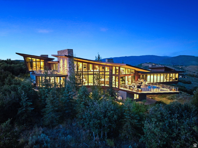 Rear view of property featuring a chimney and a mountain view