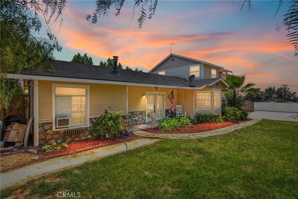 a front view of a house with a yard table and chairs