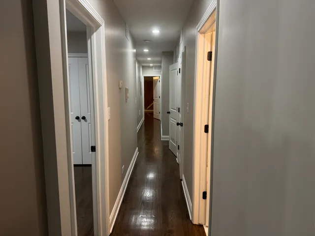 a view of hallway with wooden floor