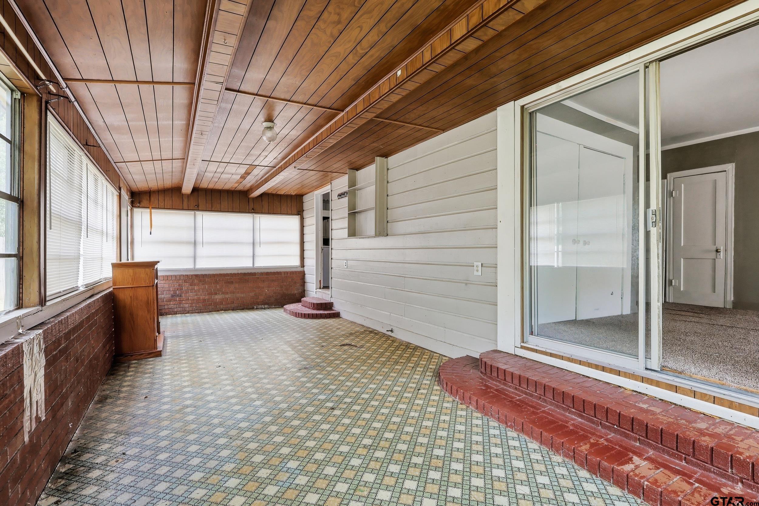 405 Rusk Street Pittsburg, TX 75686 - Photo 16 of 33 a view of a porch with a table and chairs