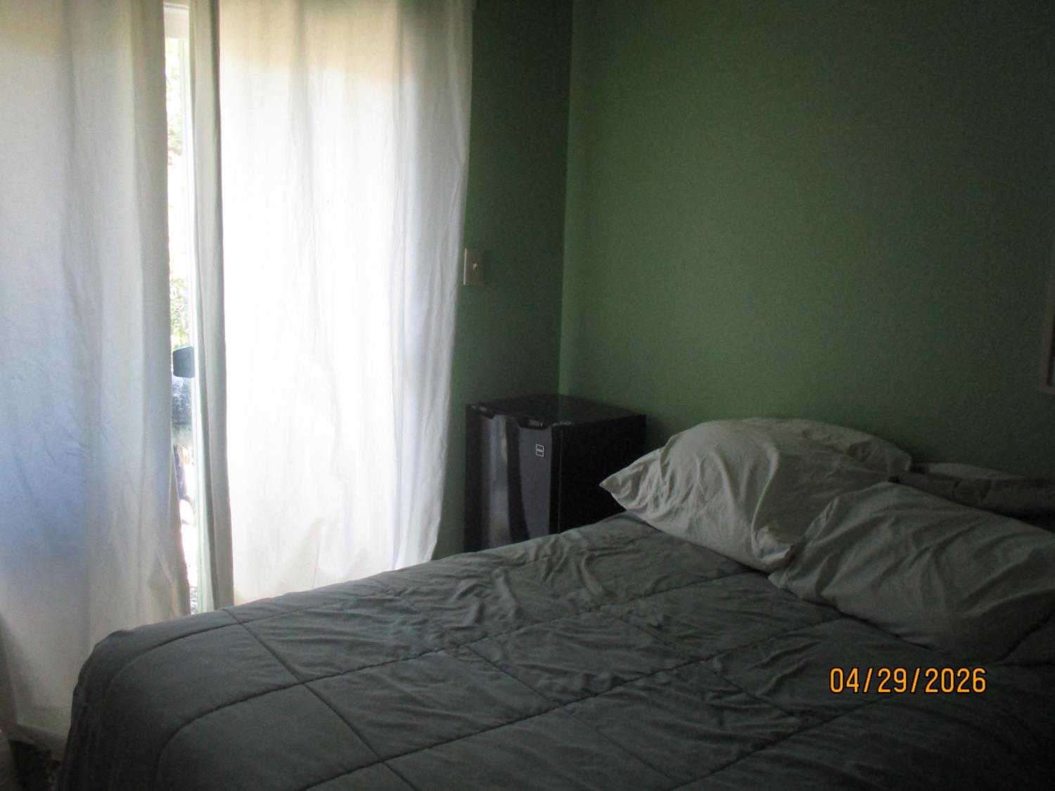 11024 Autumnwind Lane Rancho Cordova, CA 95670 - Photo 27 of 36 a bed sitting in a bedroom next to a window