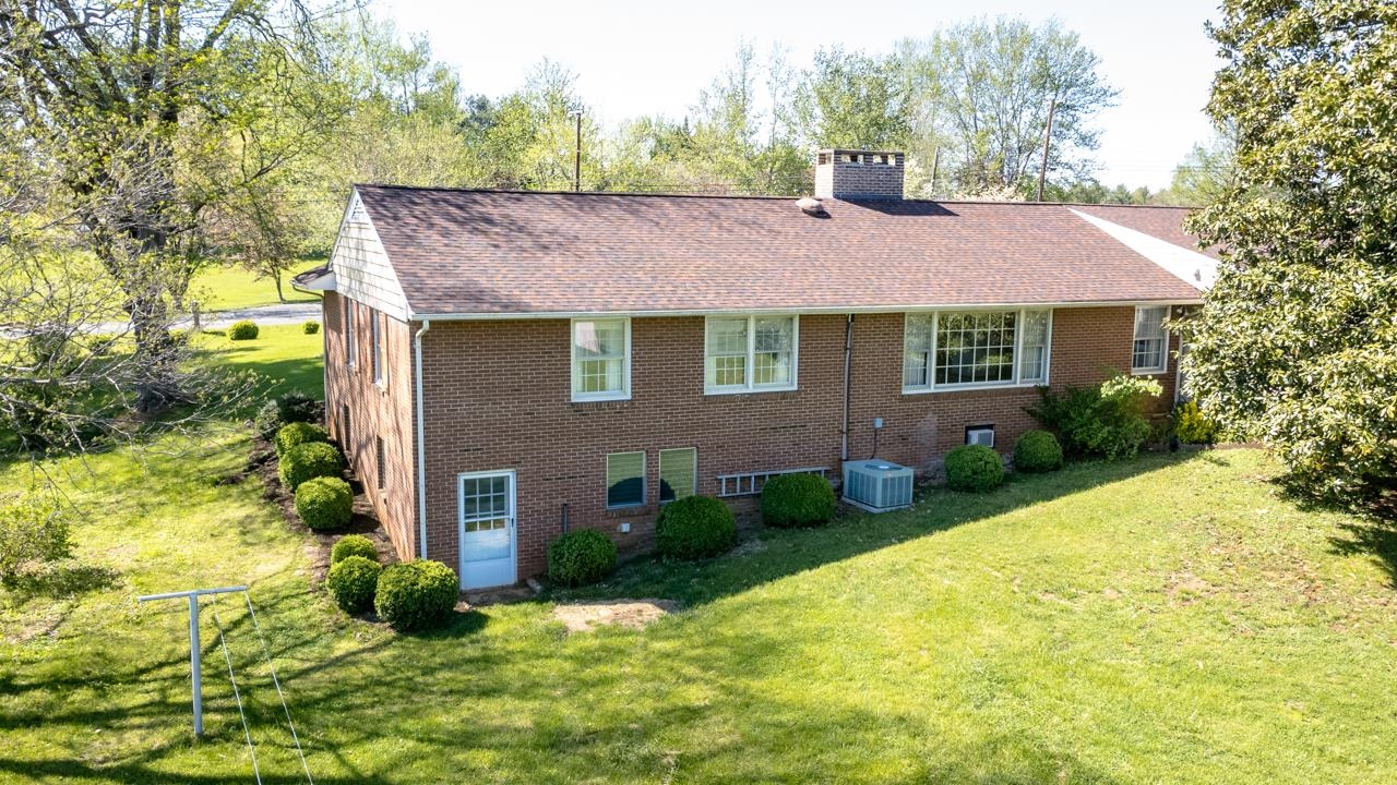 27 Cattle Scales Road Waynesboro, VA 22980 - Photo 54 of 55 a brick house with a yard plants and large tree