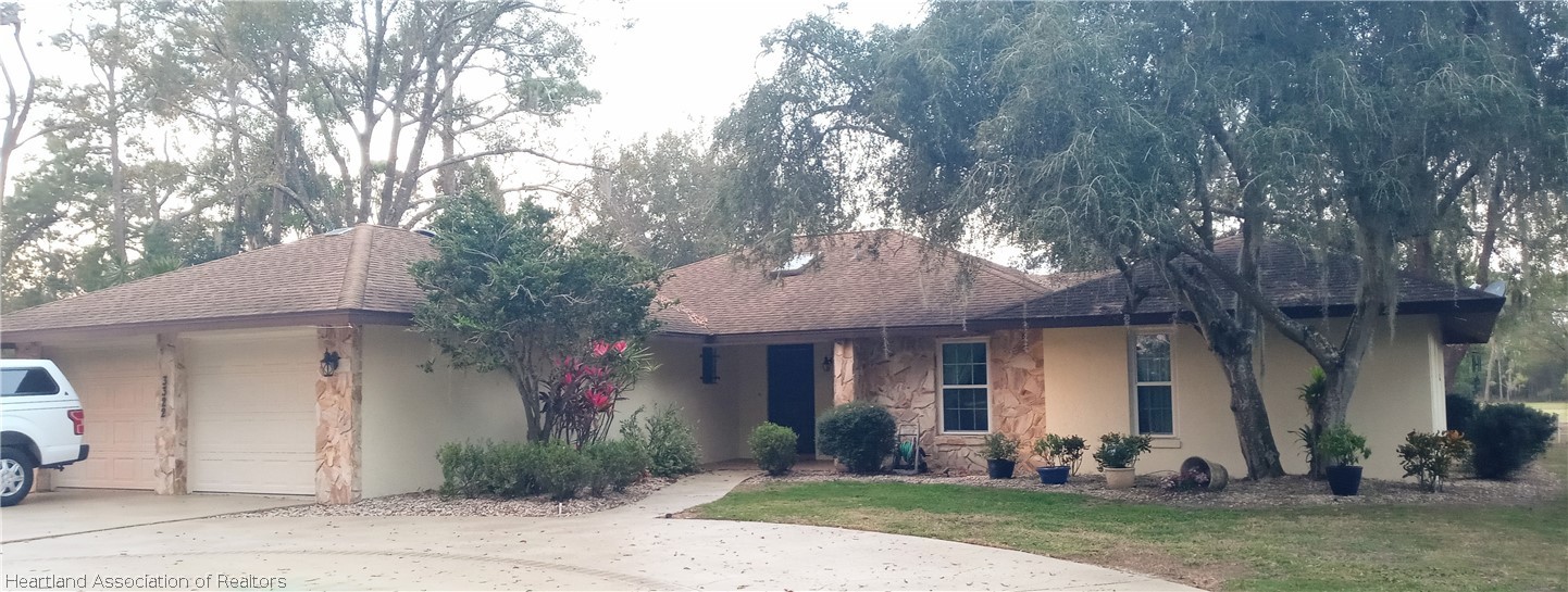 3322 Golfview Road Sebring, FL 33875 - Photo 1 of 1 a front view of a house with a yard and tree s