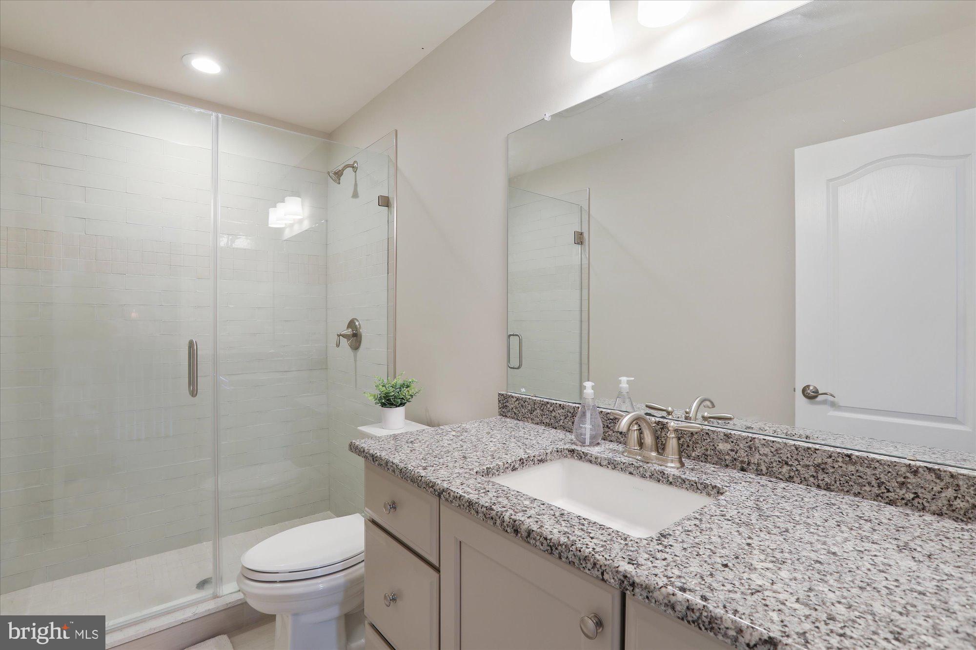 149 King Road Chalfont, PA 18914 - Photo 54 of 63 a bathroom with a granite countertop sink a toilet and shower