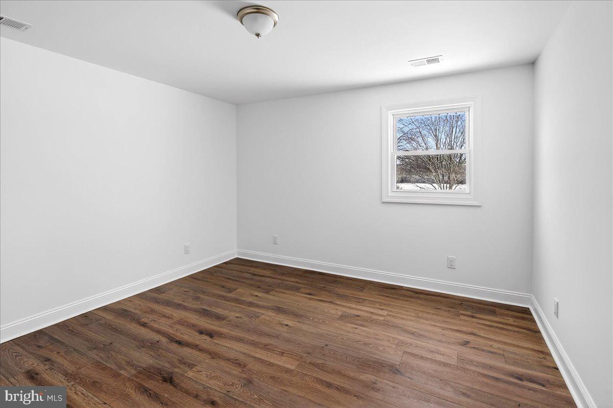 464 Sykesville Road Wrightstown, NJ 08562 - Photo 23 of 32 an empty room with wooden floor and windows