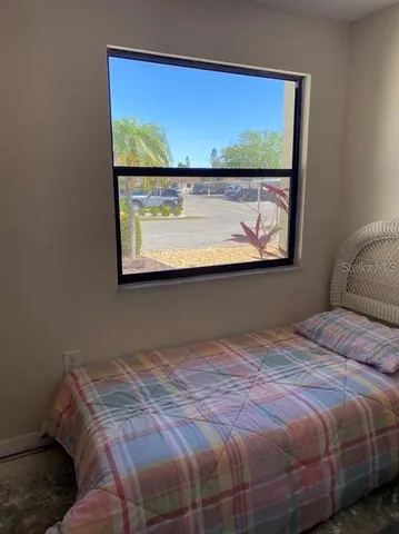 a bedroom with a bed and window