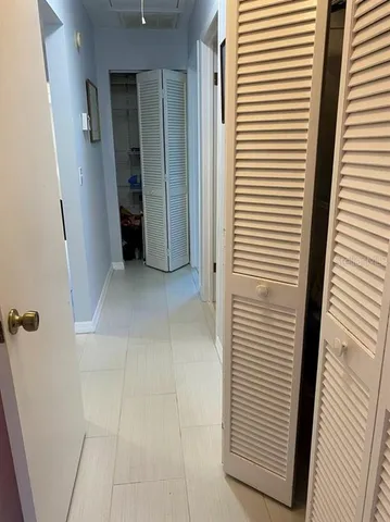 a bedroom with a bed and a large mirror