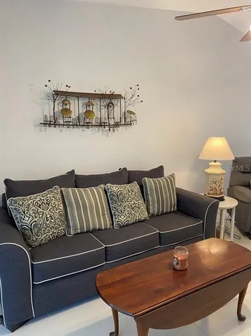 a living room with furniture and a lamp