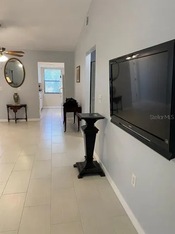 a living room with couches and a flat screen tv